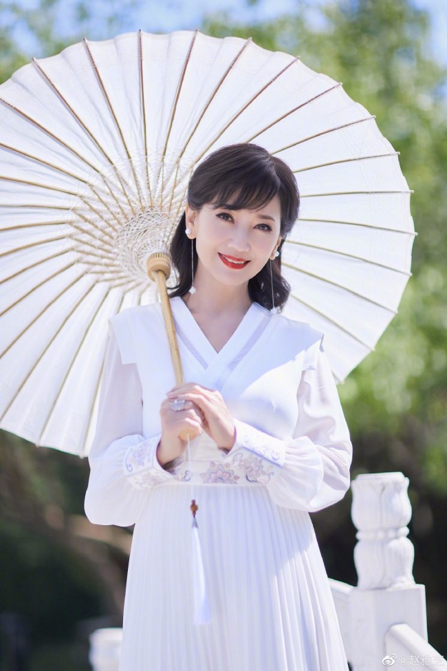 68岁赵雅芝穿白裙优雅迷人 撑油纸伞漫步桥上